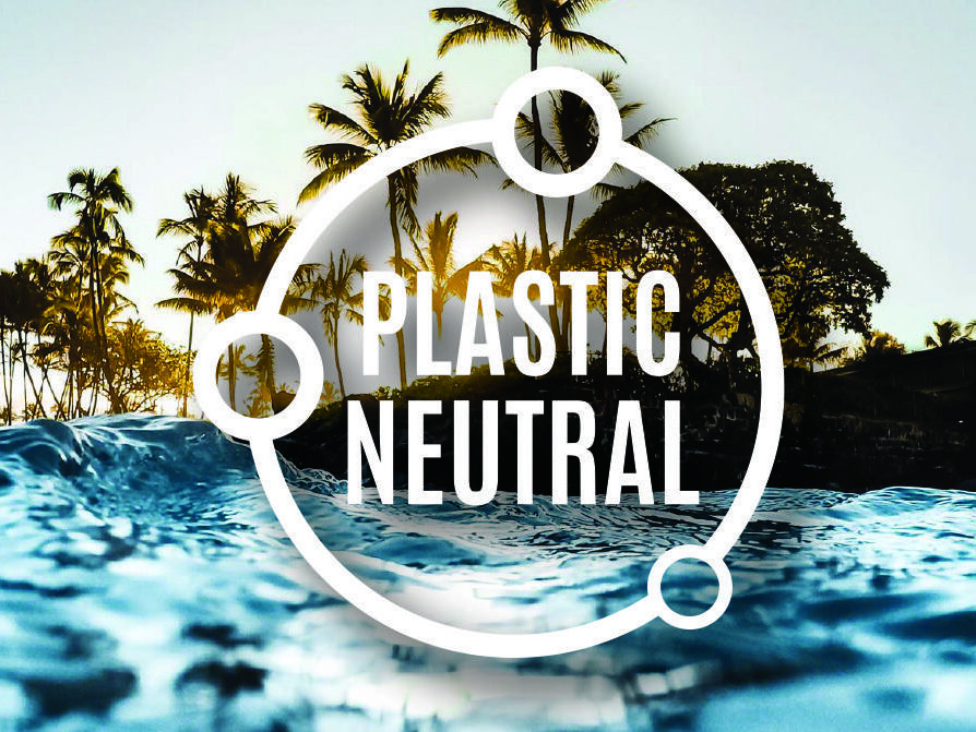 An ocean wave in the foreground with palm trees silhouetted against a sunset sky in the background. Overlaid on the image is a circular emblem with the text "Plastic Neutral" inside.