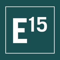 A green square logo with a white border featuring the text "E15" in bold, white font. The "E" is large and positioned to the left, while the "15" is smaller and aligned to the top right of the "E".