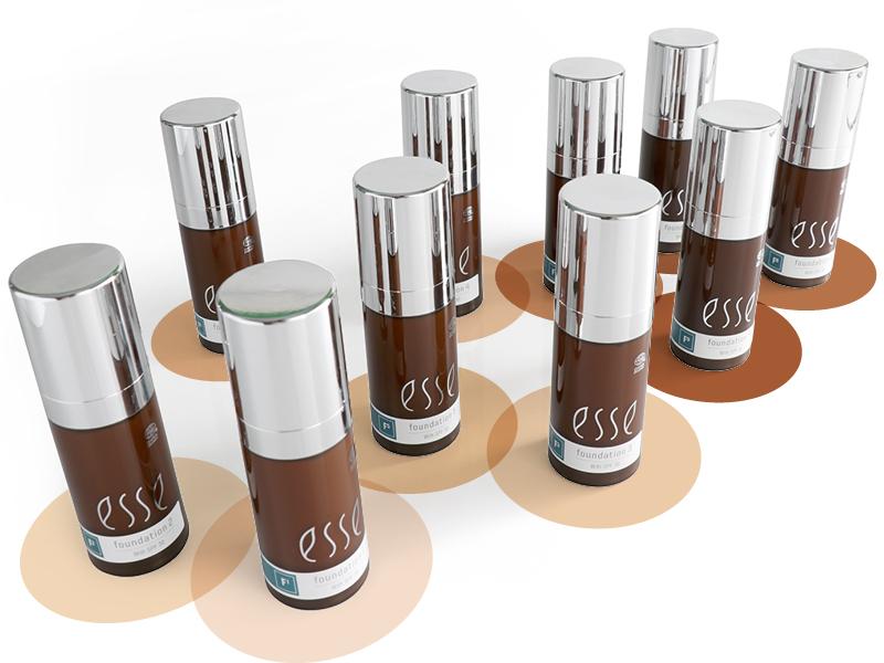 A collection of ten brown, cylindrical bottles with silver caps arranged in a triangular formation. Each bottle is labeled "esse foundation" and stands on circular swatches of different shades, indicating the range of foundation colors available.